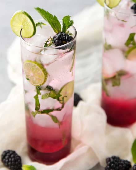 A fun summer twist on the classic mojito, this blackberry mojito is made with an easy homemade blackberry simple syrup, mint, lime, rum and club soda! | #mojito #blackberry #blackberrymojito #cocktail #summer #summerdrink