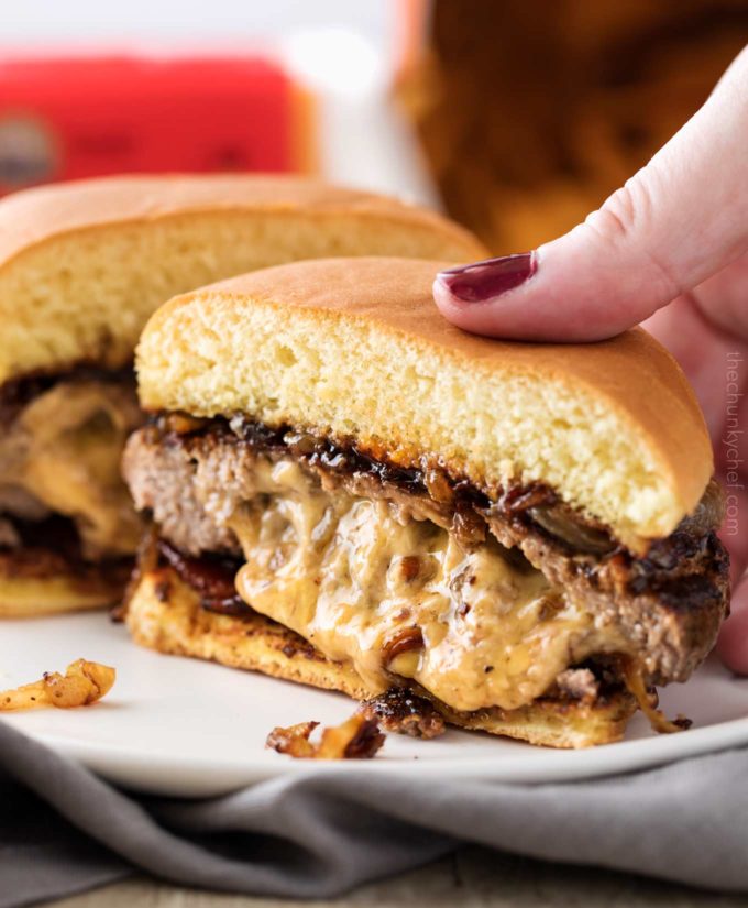 Picking up a juicy Lucy burger with gooey cheese