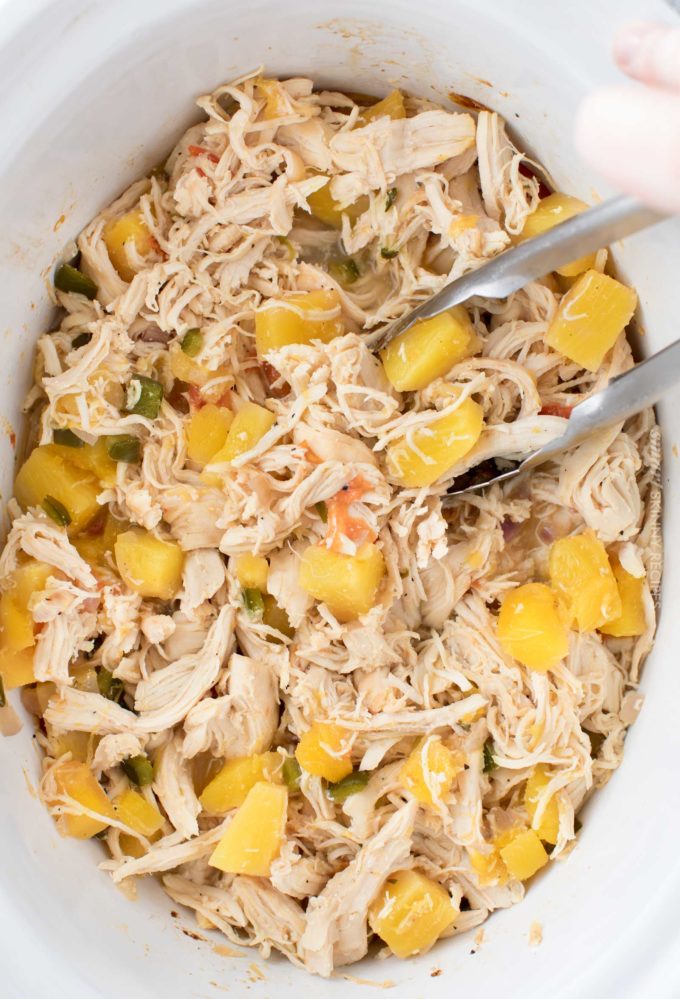 Crockpot chicken tacos in white slow cooker