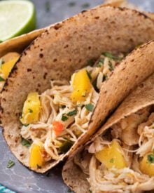 Tender, juicy, sweet and spicy crockpot chicken tacos, perfect for taco night! Just 1 freestyle smart point per serving means you can have tacos without the guilt! | #chickentacos #tacotuesday #crockpot #slowcooker #weightwatchers