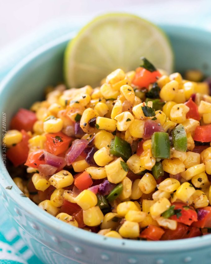 This Southwest cilantro lime corn salad is bold, healthy, and incredibly versatile!  At zero smart points per serving, feel free to pile it on tacos for an amazing meal! 