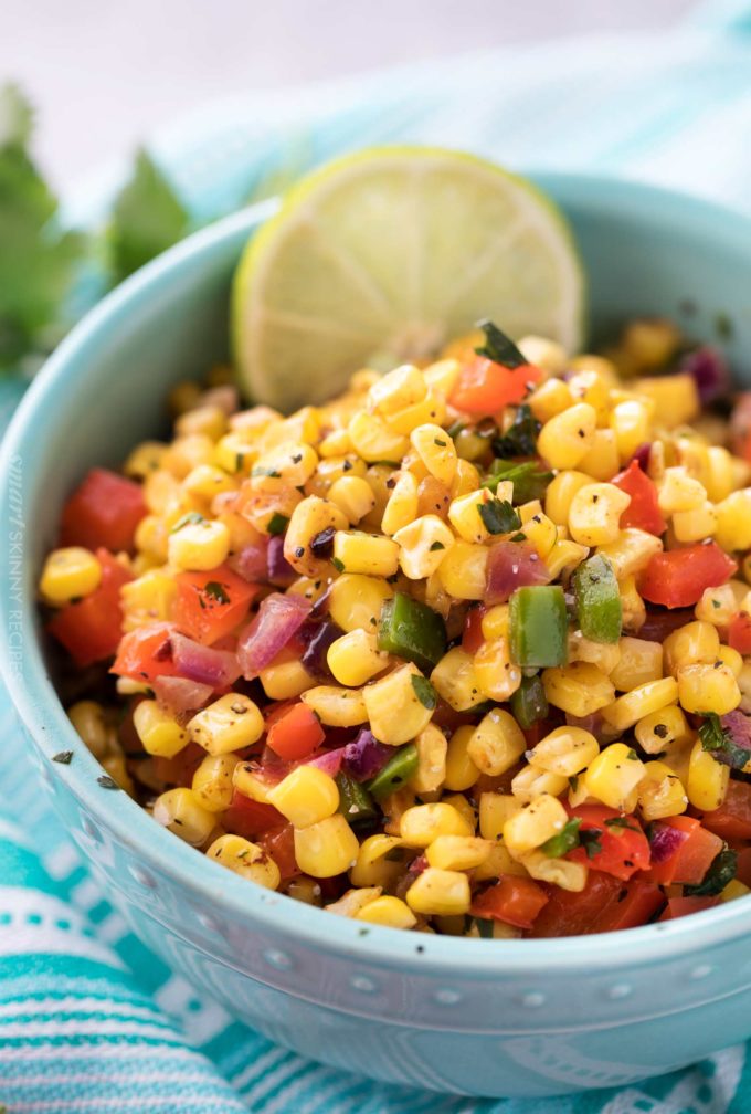 Healthy corn salad in blue bowl with lime