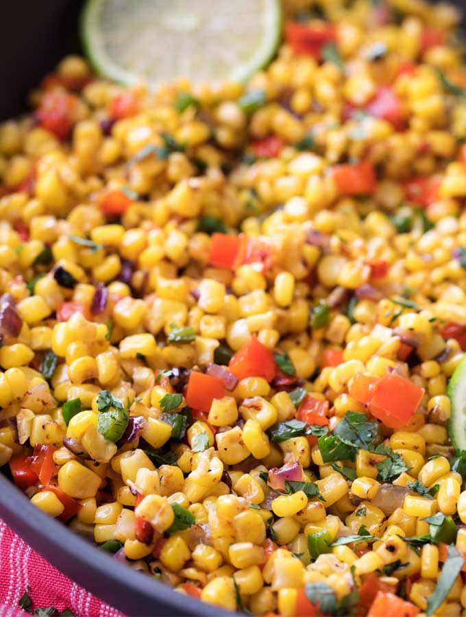 This Southwest cilantro lime corn salad is bold, healthy, and incredibly versatile!  At zero smart points per serving, feel free to pile it on tacos for an amazing meal! | #cornsalad #mexican #southwest #cilantro #lime #tacotuesday