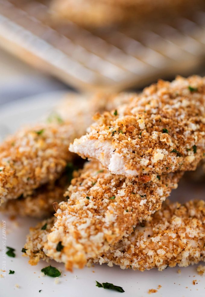 Baked chicken tender with bite taken out of it