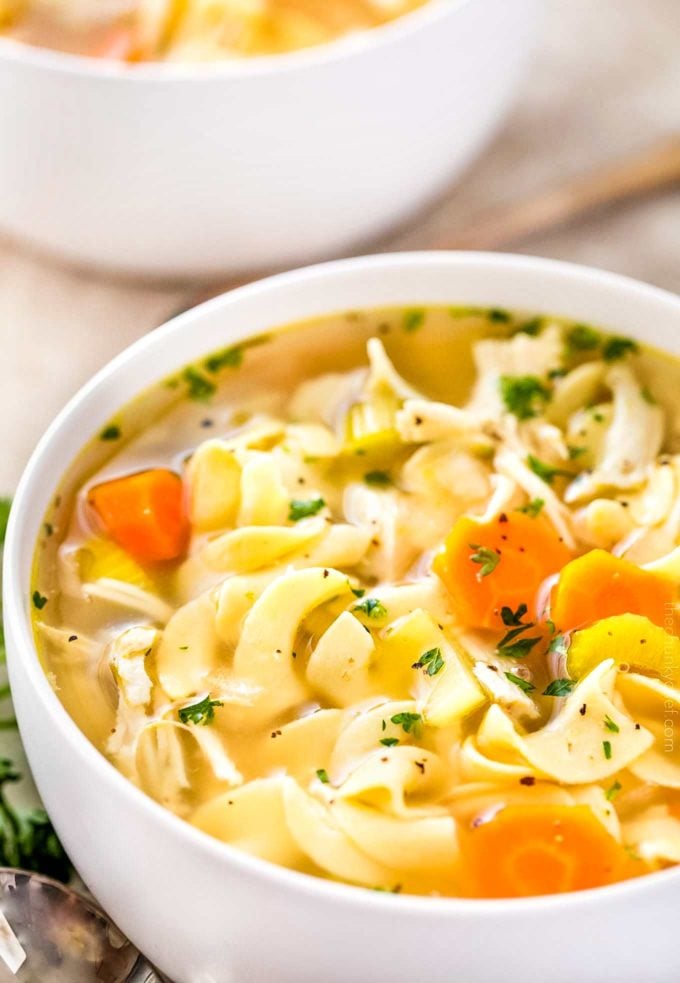 Crockpot chicken noodle soup in white bowl