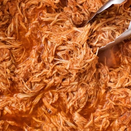 Incredible pulled BBQ chicken made easy in the crockpot... made from scratch with no bottled bbq sauce!  Perfect for a summer bbq or picnic! | #bbqchicken #pulledchicken #crockpotchicken #weightwatchers #freestyle #smartpoints