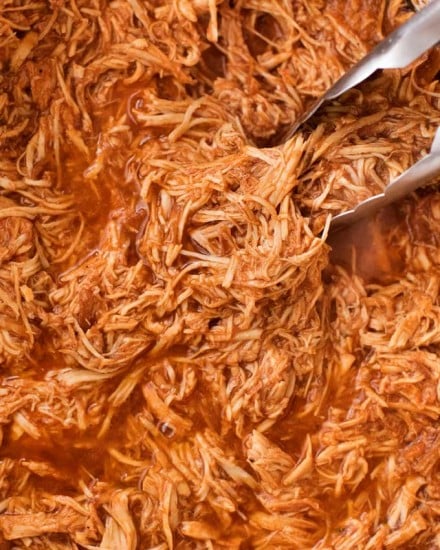 Incredible pulled BBQ chicken made easy in the crockpot... made from scratch with no bottled bbq sauce!  Perfect for a summer bbq or picnic! | #bbqchicken #pulledchicken #crockpotchicken #weightwatchers #freestyle #smartpoints