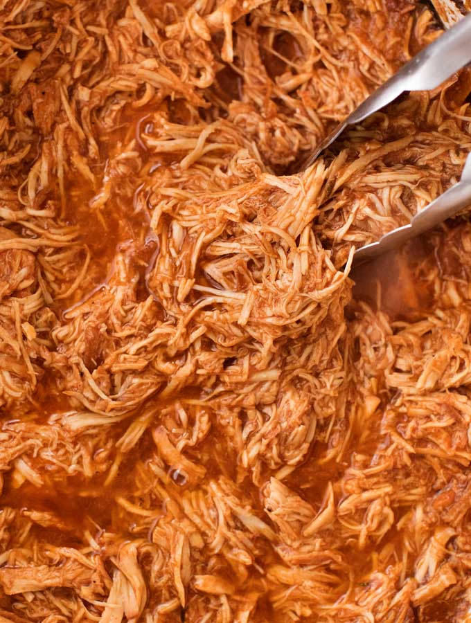 Incredible pulled BBQ chicken made easy in the crockpot... made from scratch with no bottled bbq sauce!  Perfect for a summer bbq or picnic! | #bbqchicken #pulledchicken #crockpotchicken #weightwatchers #freestyle #smartpoints