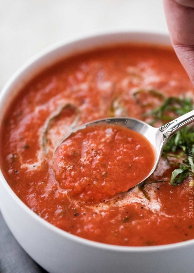 Spoonful of tomato soup with basil