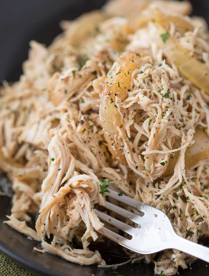 Easy all-purpose shredded chicken made in the crockpot with spices and beer.  Make a big batch and use it to make different meals all week long! | #chicken #shreddedchicken #pulledchicken #beer #braised #allpurpose #multipurpose #slowcooker #crockpot