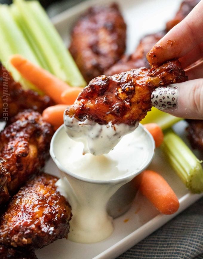 Smoked chicken wings dipped in ranch dressing