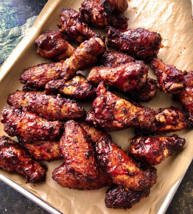 Insanely tasty chicken wing recipe, dry rubbed, then hickory smoked to perfection.  And don't forget the homemade bourbon bbq sauce! #chickenwings #wingrecipe #smoked #smoker #smokedchickenwings #bourbon #bbq #crispy