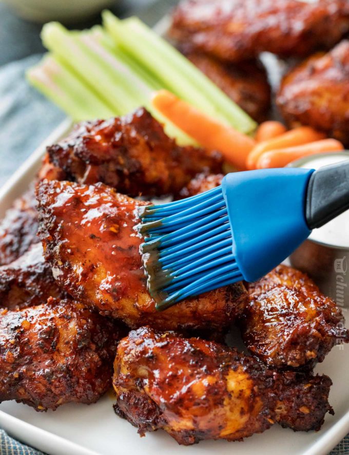 Brushing homemade bbq sauce on chicken wings