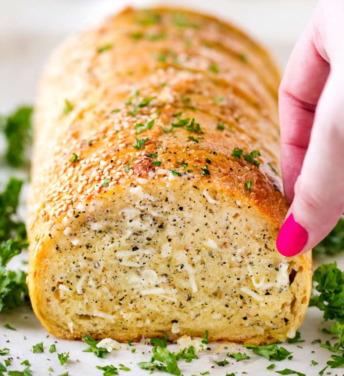 Taking a slice of garlic bread