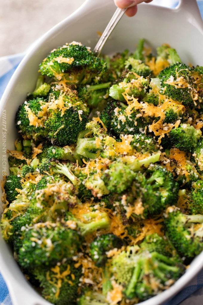 Cheesy roasted broccoli in white baking dish
