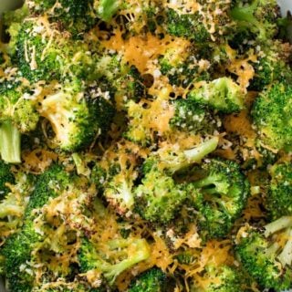 Simple ingredients and an easy 5 minutes of prep is all it takes to get this mouthwatering roasted broccoli in the oven! You'll love the cheesy topping, and even non-veggie lovers will go crazy over this healthy side dish!! #broccoli #roastedbroccoli #weightwatchers #freestyle #smartpoints