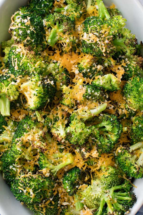 Simple ingredients and an easy 5 minutes of prep is all it takes to get this mouthwatering roasted broccoli in the oven!  You'll love the cheesy topping, and even non-veggie lovers will go crazy over this healthy side dish!! #broccoli #roastedbroccoli #weightwatchers #freestyle #smartpoints