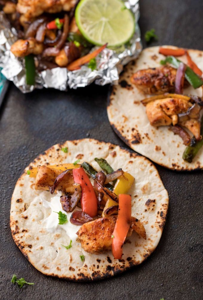 Foil packet dinner of chicken fajitas on flour tortilla