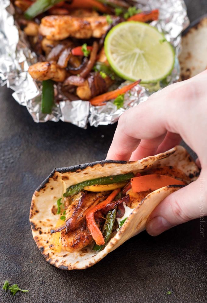 Grabbing a chicken fajita made in a foil packet