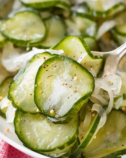Sweet and tangy with PLENTY of crunch, these freezer pickles perfect year-round!  No complicated canning steps or equipment needed! #pickles #homemade #freezerpickles #cucumbers #farmersmarket #gardenfresh #howto