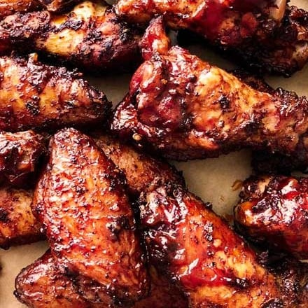 Insanely tasty chicken wing recipe, dry rubbed, then hickory smoked to perfection.  And don't forget the homemade bourbon bbq sauce! #chickenwings #wingrecipe #smoked #smoker #smokedchickenwings #bourbon #bbq #crispy