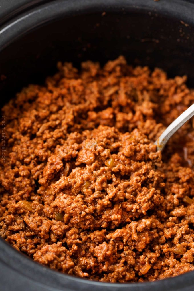 Big spoonful of beef taco meat in slow cooker