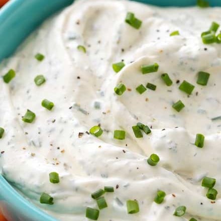 Perfect for football parties or any gathering, this creamy vegetable dip is full of garlic and herb flavors!  Plain ranch can't hold a candle to this easy veggie dip! #dip #diprecipe #vegetables #veggiedip #partyfood #snacks