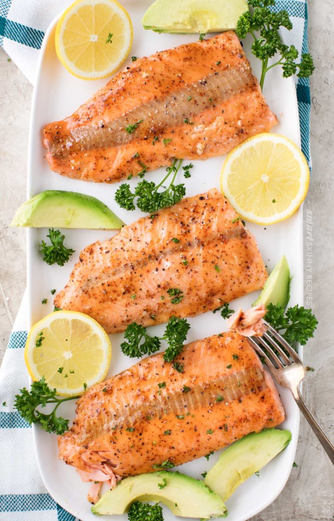 Broiled salmon filets on serving plate with citrus 