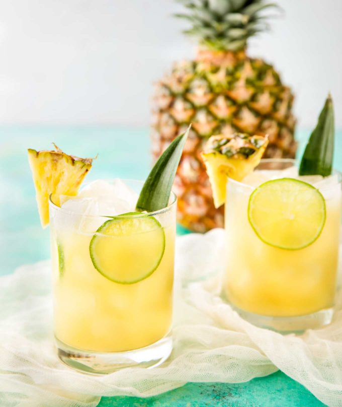 Pineapple rum punch with limes in glasses