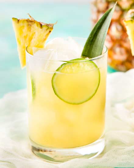 This tropical pineapple coconut rum punch is sweet and a perfect drink for a party!  Drinking this cocktail will make you feel like you're at the beach! #drinks #cocktail #pineapple #coconut #rum #tropical #party