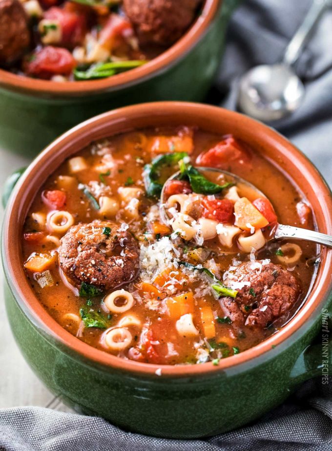 Bowl of meatball soup with cheese on top