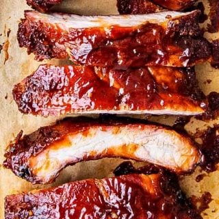 Delicious homemade smoked ribs are easier to make than you think, especially using the popular 3-2-1 method. Fall of the bone tender, and lip-smackingly good, these ribs are FABULOUS!! #ribs #pork #bbq #smoked #smoking #grilling #easyrecipe