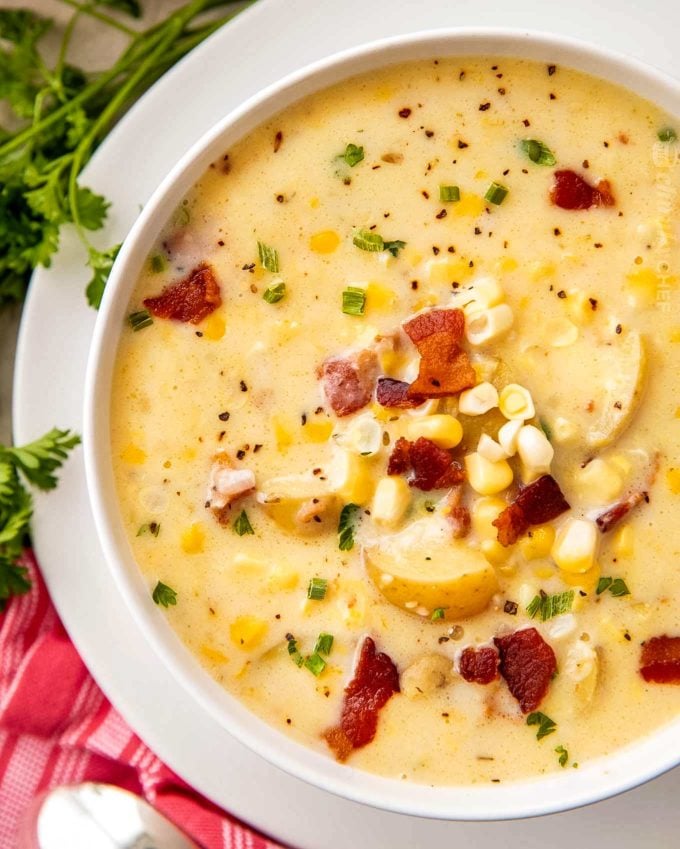 Overhead view of corn chowder in white bowl