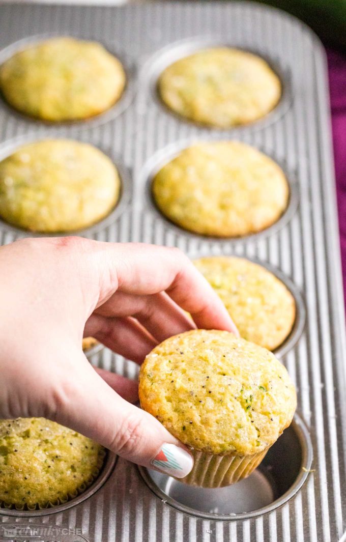 Grabbing a lemon poppy seed muffin from baking pan