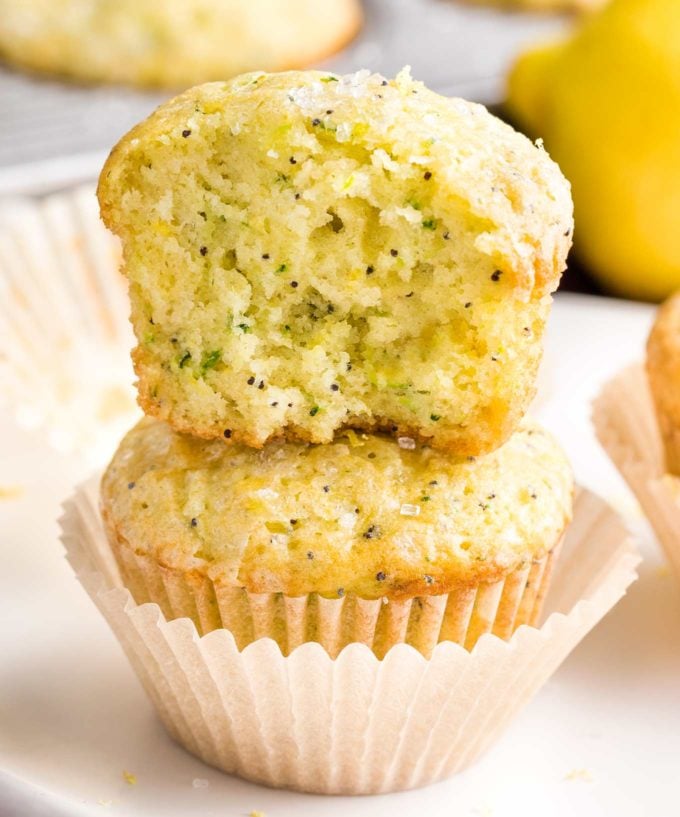 Half a lemon poppy seed muffins stacked on another muffin
