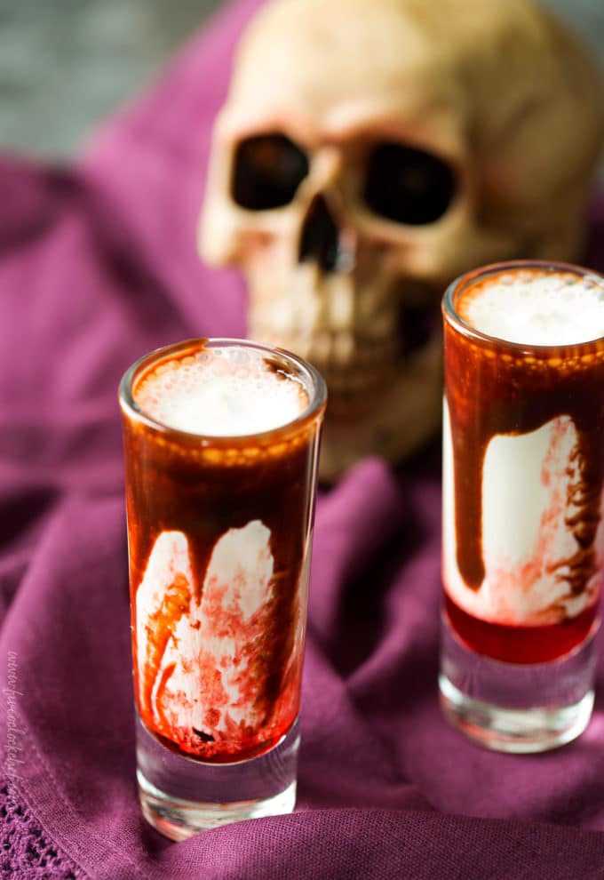 Gory and delicious, these vanilla milkshake shots take just 5 ingredients to make, and are perfect for a Halloween party! #shots #milkshake #halloween #party #fall #boozy #drink 