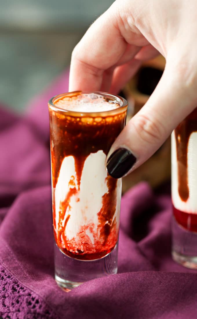 Gory and delicious, these vanilla milkshake shots take just 5 ingredients to make, and are perfect for a Halloween party! #shots #milkshake #halloween #party #fall #boozy #drink 