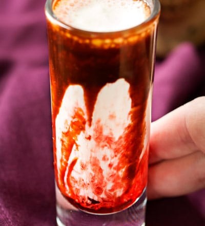 Gory and delicious, these vanilla milkshake shots take just 5 ingredients to make, and are perfect for a Halloween party! #shots #milkshake #halloween #party #fall #boozy #drink 