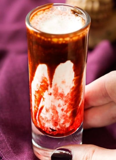 Gory and delicious, these vanilla milkshake shots take just 5 ingredients to make, and are perfect for a Halloween party! #shots #milkshake #halloween #party #fall #boozy #drink 