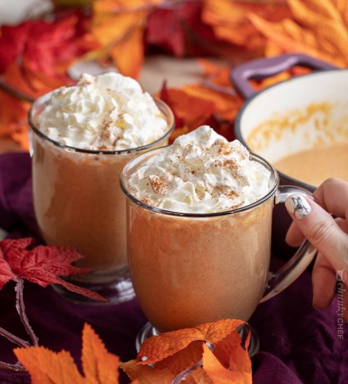 Holding a mug of pumpkin hot chocolate with pumpkin spice