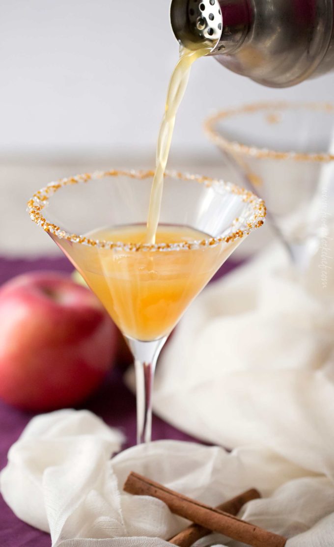 Pouring apple martini from shaker into glass