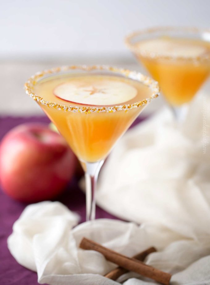 Sweet spiced apple cider mixed with caramel flavored vodka, shaken over ice and served with a slice of sweet apple as a garnish! #martinirecipe #applemartini #vodka #applecider #falldrink #fall #caramelapple #caramel #vodka