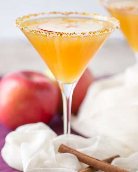 Sweet spiced apple cider mixed with caramel flavored vodka, shaken over ice and served with a slice of sweet apple as a garnish! #martinirecipe #applemartini #vodka #applecider #falldrink #fall #caramelapple #caramel #vodka