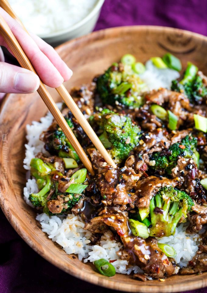 Wooden bowl of beef and broccoli over rice