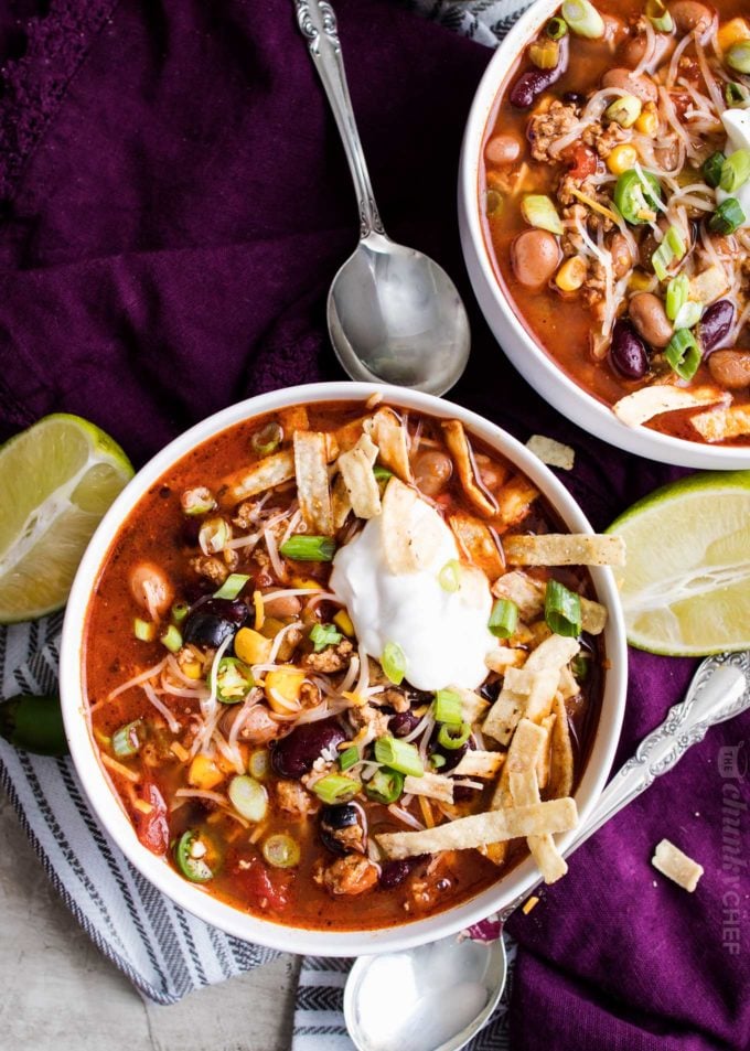 Two white bowls of taco soup made in the crockpot