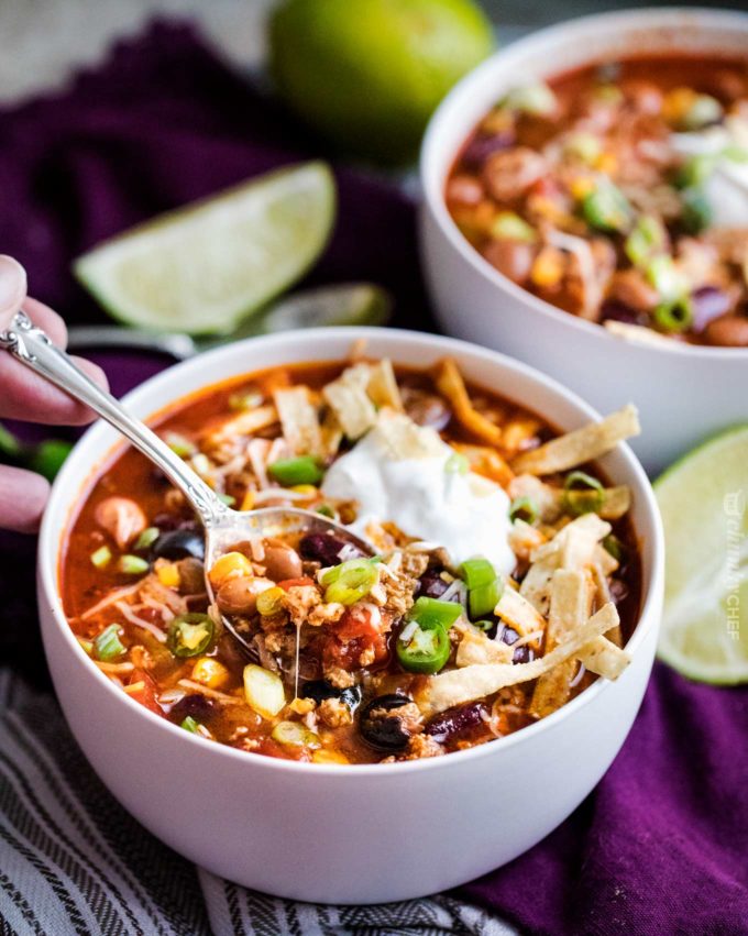 Spoonful of crockpot taco soup in white bowl