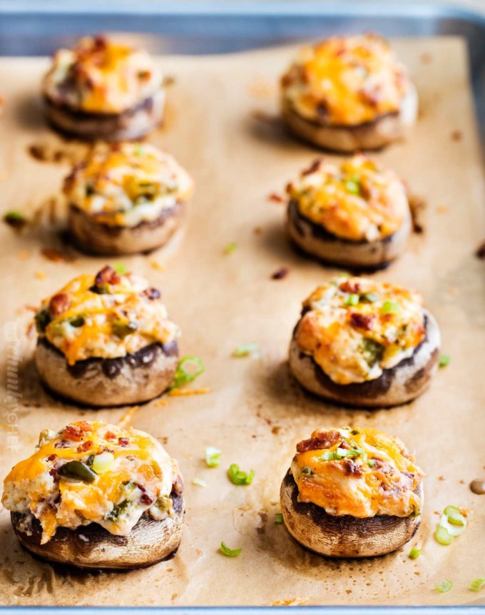 Baked stuffed mushrooms on parchment lined baking sheet