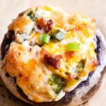 This epic game day food is all the deliciousness of a cheesy jalapeno popper, stuffed into mushrooms!  Spicy, creamy, and super cheesy, this is the appetizer your guests really want! #stuffedmushrooms #mushrooms #jalapeno #jalapenopopper #cheesy #appetizer #gameday #partyfood #easyrecipe