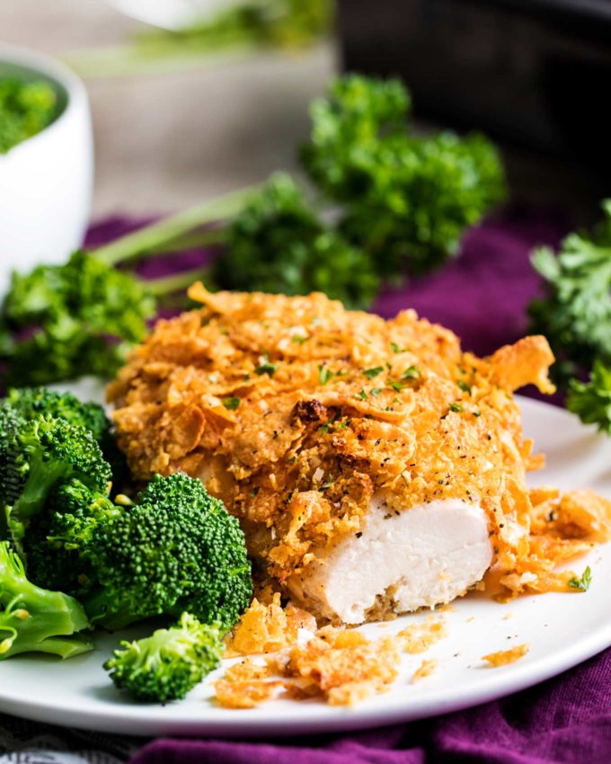 Baked chicken with cornflakes on white plate