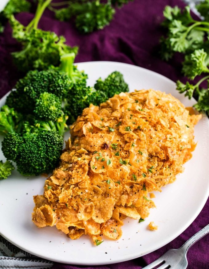 Baked cornflake chicken on plate with broccoli